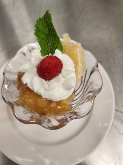 Dessert served with raspberry and mint garnish
