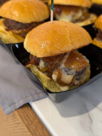 Close-up of gourmet sliders on a serving tray