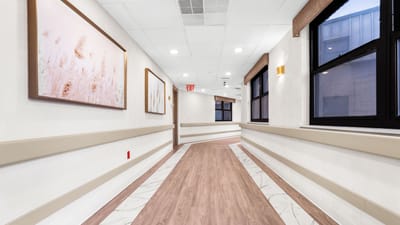 A well-lit corridor in a senior living facility