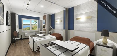 Renovated resident room with two beds and a view