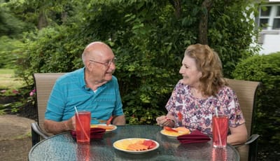 Residents enjoying a meal outdoors in the garden