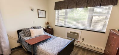 Cozy private resident room with a bed and window
