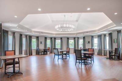 Common area with tables and chairs for residents