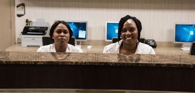 Reception staff smiling at the desk