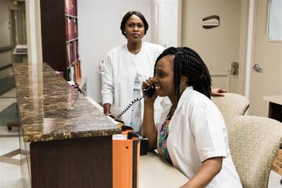 Staff members at the reception desk interacting