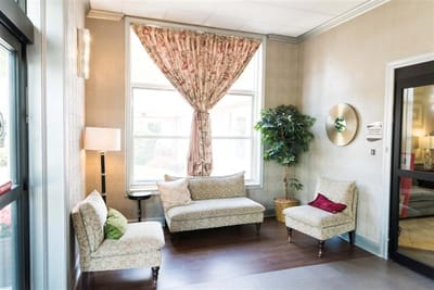 Cozy seating area with floral curtains and plants