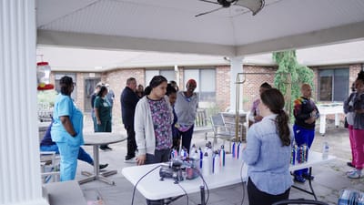 Residents and staff socializing during an outdoor activity