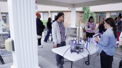 Residents and staff celebrating an event outdoors