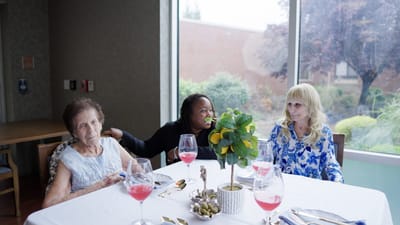 Residents enjoying a meal at a dining table