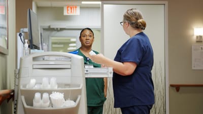 Staff members discussing in a facility hallway