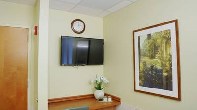 Interior view of a facility room with a TV and artwork