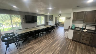 Bright common area with large table and seating