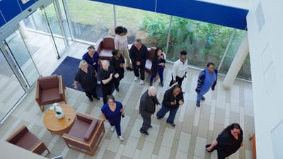 Staff and residents interacting in a bright lobby area