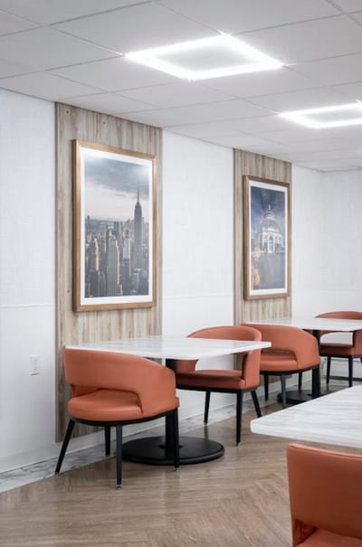 Bright dining area with modern seating and artwork