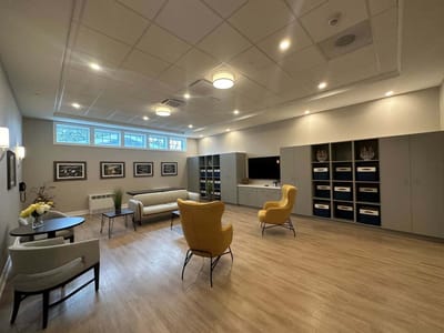 Bright common area with seating and storage cabinets