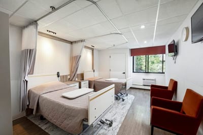 A well-furnished resident room with two beds