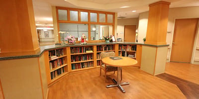 Bright common area with bookshelf and table