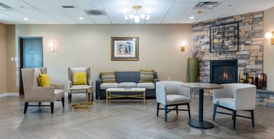 A cozy common area with seating and a fireplace