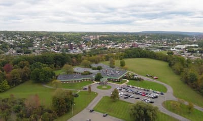 Aerial view of a senior living facility surrounded by green fields