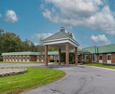 Entrance of a senior living facility with a covered walkway