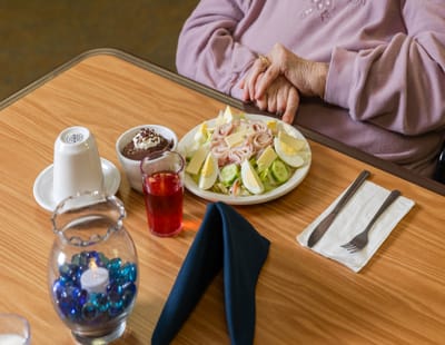 A resident enjoying a meal in the dining area