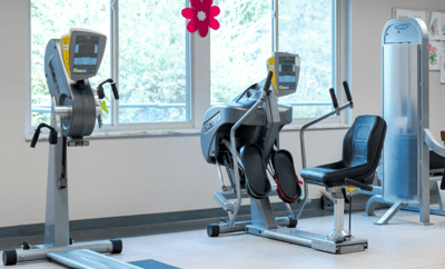 Exercise equipment in a senior living fitness room