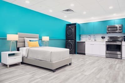 Modern kitchenette and bedroom setup in a resident unit