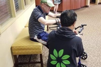 A resident and staff member interacting in a common area