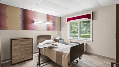 A cozy resident room with a view of the outdoors