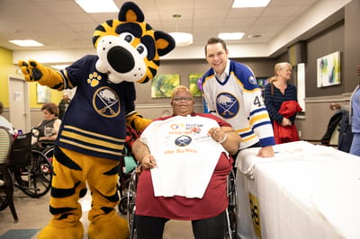 Residents and mascot celebrating in a common area