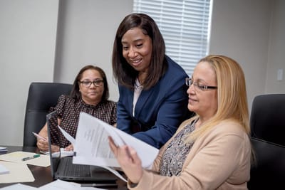 Bronxcare Special Care Center, Nursing Home in Bronx, NY — Staff collaborating in a meeting with documents and laptop