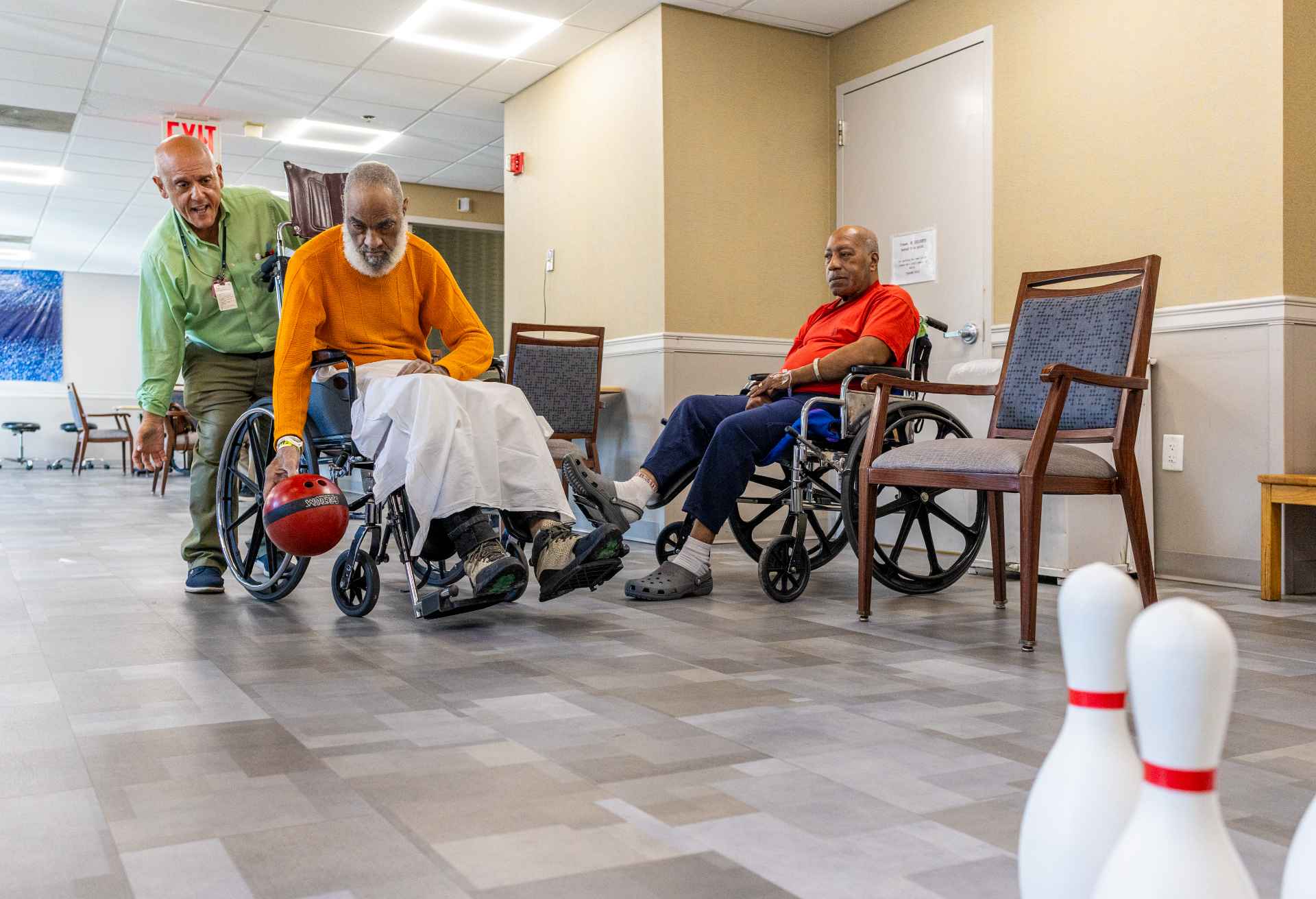 Residents enjoying a bowling game in the activity room