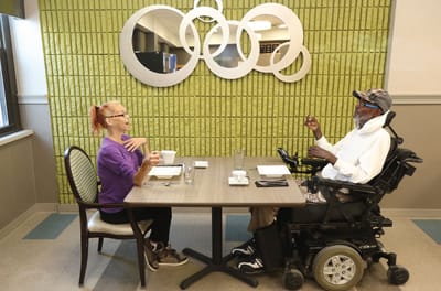 Two residents enjoying coffee in a dining area