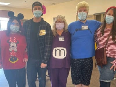 Staff and residents dressed in costumes during an activity