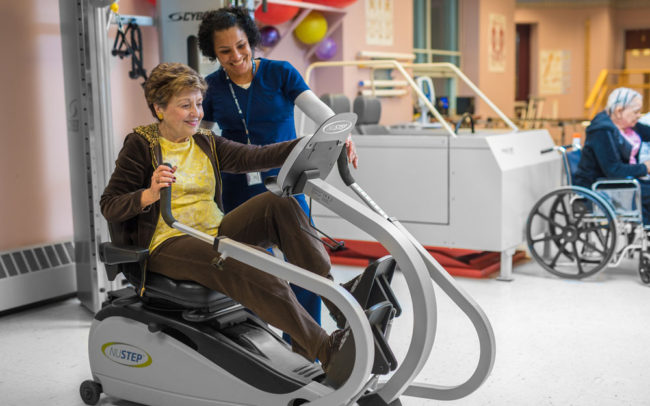 Residents engaging in an exercise activity with staff guidance
