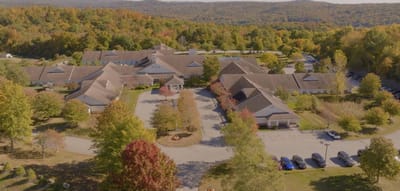 Putnam Ridge, Nursing Home in Brewster, NY — Aerial view of a senior living facility surrounded by trees