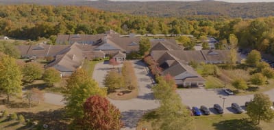 Aerial view of the senior living facility surrounded by fall foliage