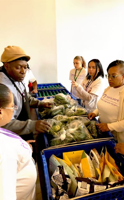 Volunteers distributing fresh produce to residents