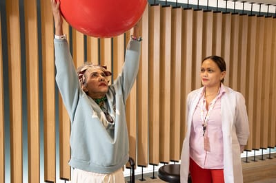Senior resident participating in an exercise session with staff