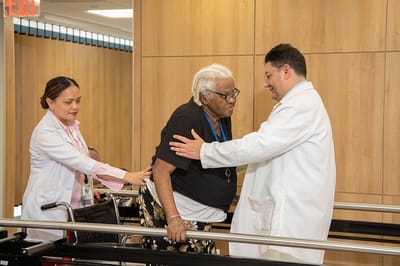 Health professionals assisting a resident in a facility