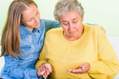 Caregiver assisting a resident with medication