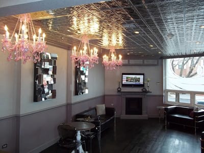 Interior lounge area with pink chandeliers and seating