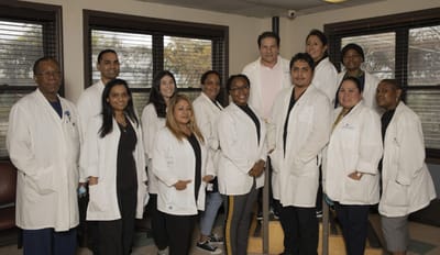 Staff group photo in a bright facility interior