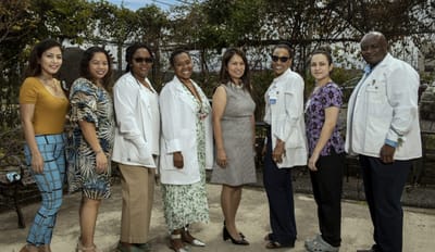Staff members posing outside in a friendly atmosphere