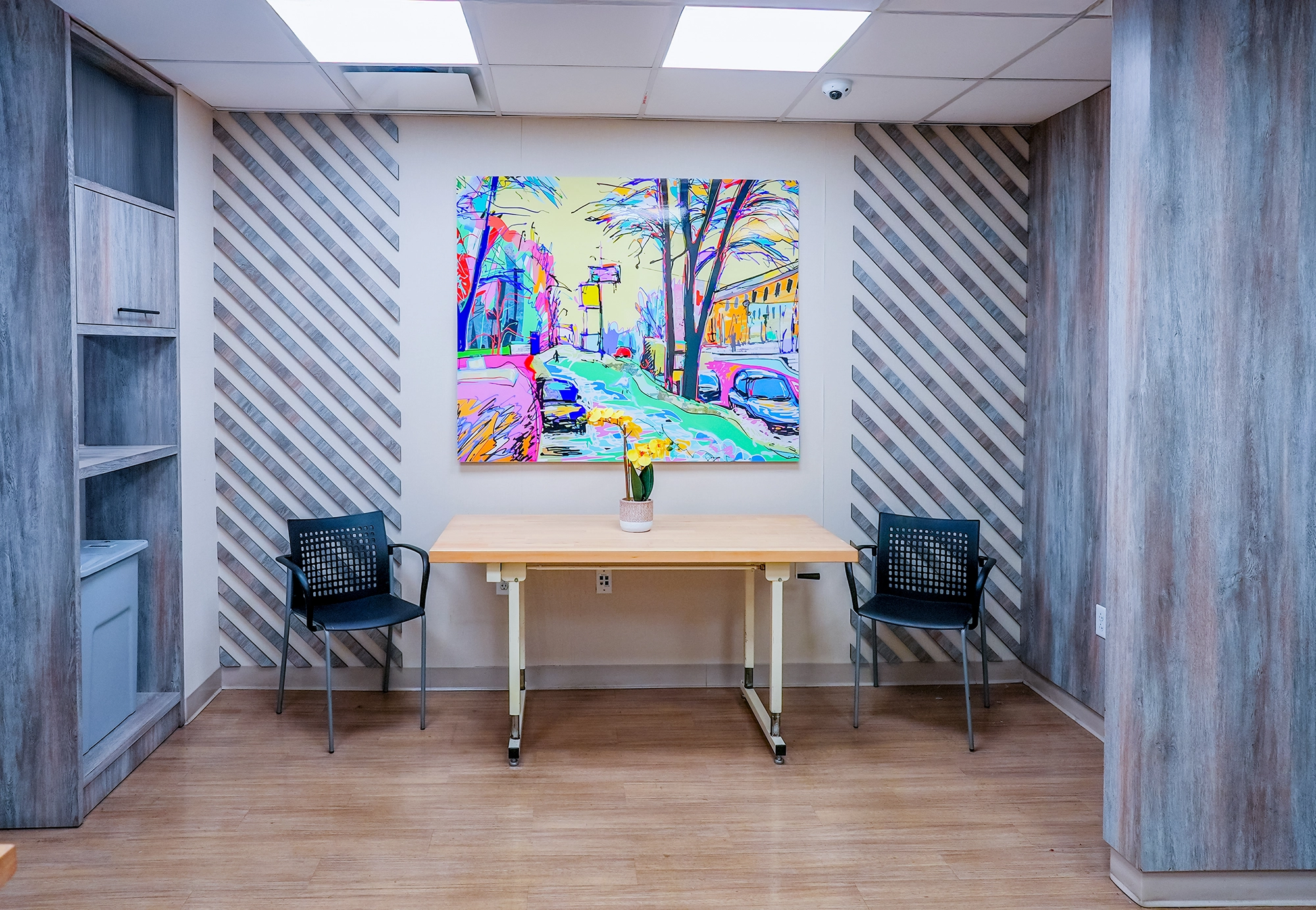 Bright common area with decorative artwork and tables