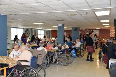 Residents and staff engaged in activities in a common area