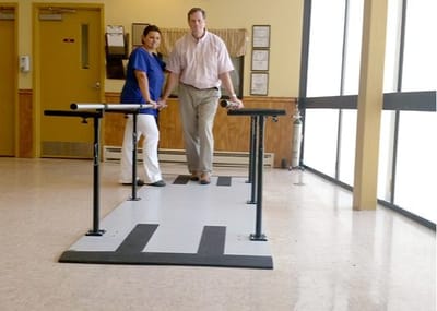 Therapist assisting a resident in a rehabilitation area