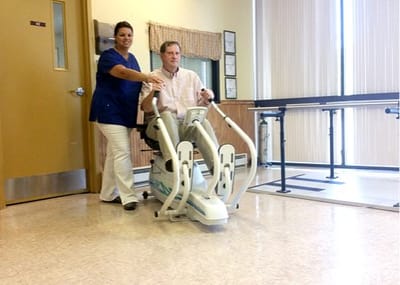 Staff assisting a resident with mobility equipment