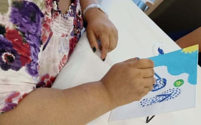 A resident painting during an art activity