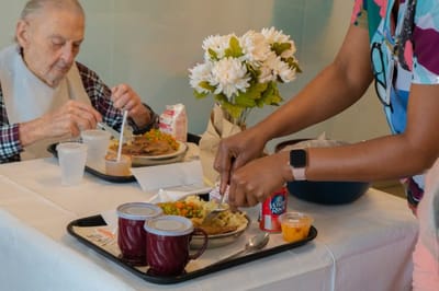 Residents enjoying meals together in a dining area